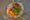 a plate with bao bun, fresh meat and salad on top
