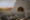 a white wall goes down into a bench with a small window in it that has a fire going and opposite is a small table made with a white cloth, wine and cheese and in the distance you can see a sun set over a vineyard