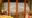 image of snow capped mountains in the reflected of glass double doors and on either side are tables and chairs blurred