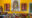 Chanoud Garh in india a yellow wall with a square hole in the wall and two rectangular spaces either side, and a table in front that is laden with spices and vegetables