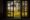a wooden window has the middle section open and looking out onto fields and trees and hills in the background showing a really peaceful setting and the sun shines a golden light onto the greenery