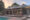 side angle of a tented lodge with a pool in front of it at sunset