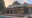side angle of a tented lodge with a pool in front of it at sunset