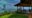 a back view of a terrace, green gardens and blue background of an ocean and sky