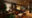 a long room with sofas and foot stalls around a patterned rug in the centre of the room and on the far wall are lamps and paintings to create a cosy looking sitting room