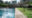 a partial view of an outdoor pool by lawn with concrete area