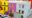 colourful yellow, grey and purple buildings next to each other