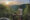 Man standing on wooden terrace next to private plunge pool looking out over forested hills below and setting sun in the distance.