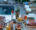 a photo of a table set for breakfast with two hard boiled eggs in egg cups, yogurt parfait, orange juice, two bowls