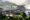 Aerial view of Upper Circuit walkway over the river near the top of Iguazu Falls, with tourists at a viewpoint looking out over the waterfall