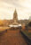 Sunset panoramic shot of a large period building with a tall spire in the middle, leading up to it is a gravel road with grass gardens on either side and a fountain in the middle.