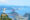 Statue of Christ The Redeemer with arms outstretched made of stone percehes on the peak of a mountain, overlooking the cityscape of Rio as well as the sea and lots of rocky islands dotted about