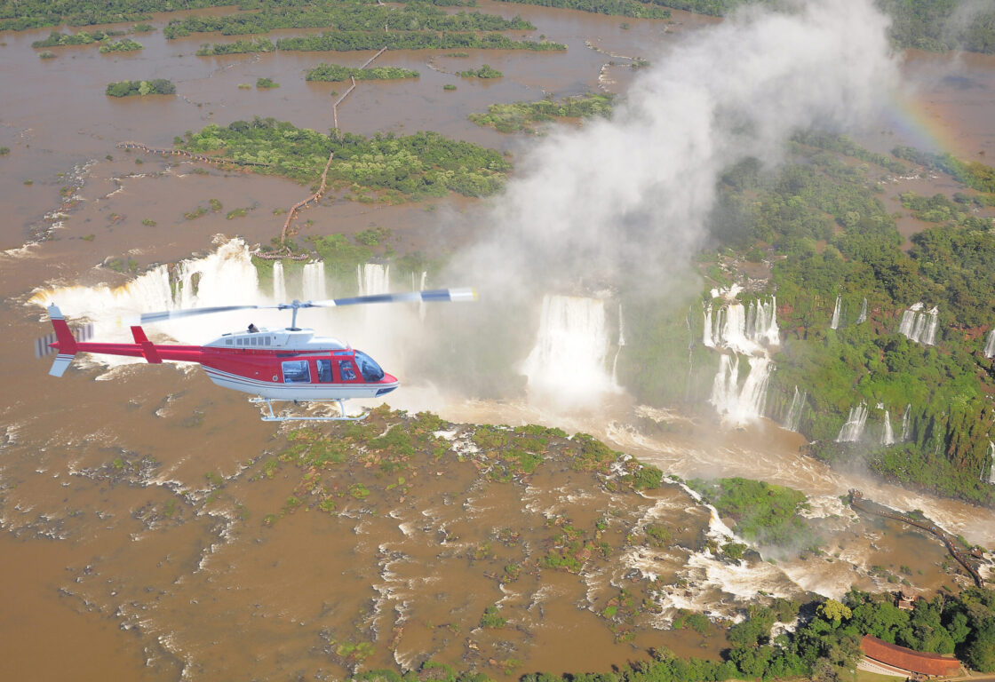 A helicopter flying over Iguazu Falls