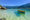 A canoe floating in crystal clear waters off the coast of Paraty, Brazil