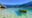 A canoe floating in crystal clear waters off the coast of Paraty, Brazil