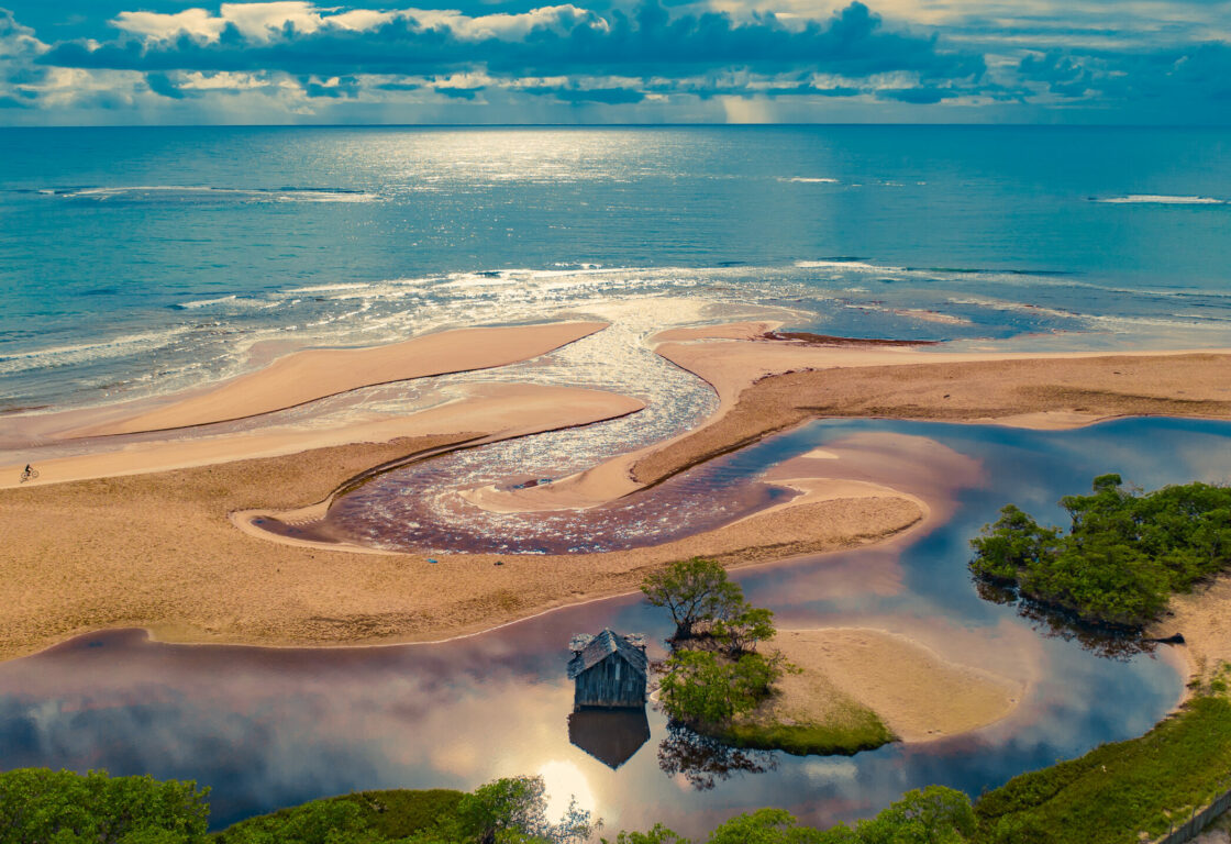 Aerial shot of the sand banks and calm waters of Praia dos Nativos, Trancoso Brazil