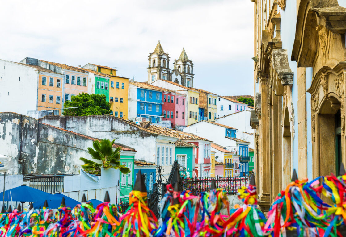 Streamers in centre of Salvador with colourful buildings in background