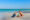 Two children playing on an idyllic beach with turquoise water behind, Brazil