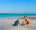 Two children playing on an idyllic beach with turquoise water behind, Brazil