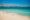 A sandy beach with teal blue waters, in the distance the rest of Valparaiso's coast, with the city buildings sprawling out into the land.