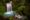 A tranquil waterfall cascades into a turquoise pool, surrounded by lush green vegetation. The scene conveys a sense of serenity and natural beauty.