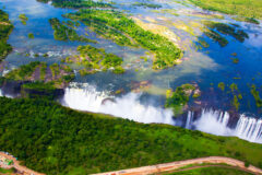aerial view of the victoria falls, showing the wide curtain of water cascading off the cliff.