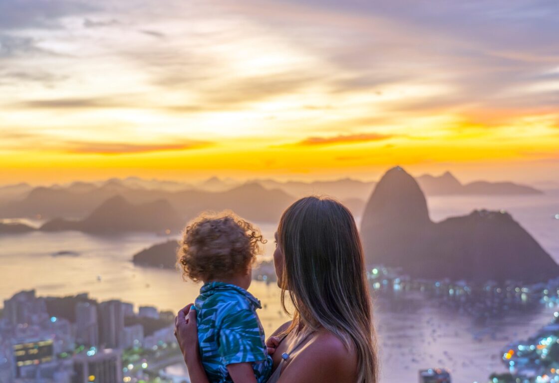 Mother and son tourists at the Dona Marta lookout overlooking the Sugar Loaf Mountain. family holiday Brazil