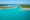 Aerial view of Sainte Marie island with a small white boat sailing towards the island, Madagascar