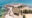 a view of a historic fort with stone walls perched on the edge of a sandy beach with ocean around it - Mozambique island (Ilha de Mocambique