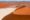 Vibrant red orange sand dunes snake through a plain for miles, against a blue sky