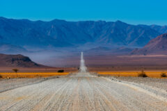 Typical Gravel Road in Namibia, long stretch with mountains in front of it