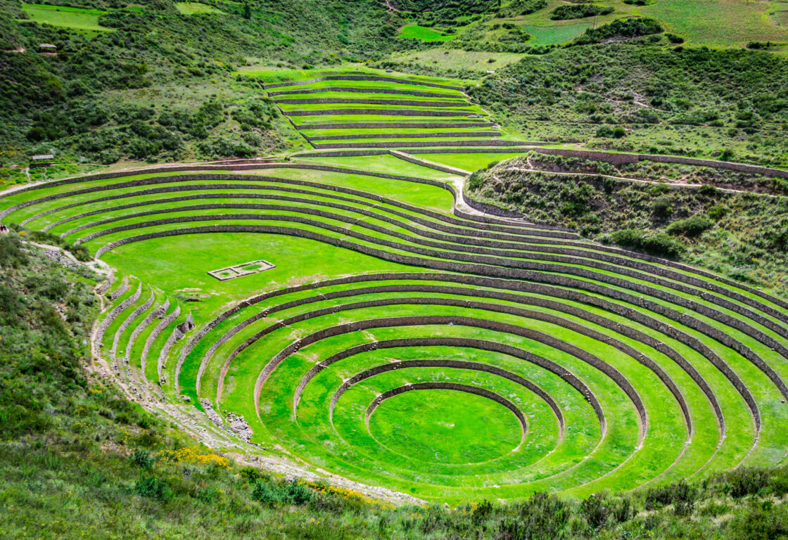 green grass circles with edges paved with stone making it look like steps in Sacred Valley in Peru