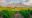lush vineyards covering the land for miles, with great rocky mountains in the background