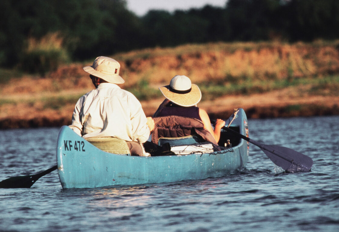 Zimbabwe, Mana Pools, Couple Canoeing at Zambezi River