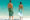 a couple walking on a beach towards the ocean
