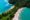 an aerial view of Manuel Antonio beaches with a long stretch of green forest and beach on each side