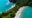an aerial view of Manuel Antonio beaches with a long stretch of green forest and beach on each side
