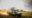 A dark green safari Land Cruiser with an open pop-up roof hatch and guests standing up through it kicks up a trail of dust as it drives across the Serengeti plains at golden hour, with warm backlit sunlight streaming across the grassland.