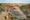 two Maasai warriors standing on an Olduvai Rock overlooking the formation in Tanzania